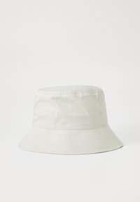 White cotton bucket hat with a rounded crown and a wide, downward-sloping brim. Smooth texture and no visible patterns or hardware.
