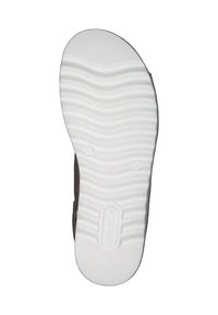 Brown footwear with a textured, white rubber sole featuring wave patterns. The sole has a logo and rounded toe design.