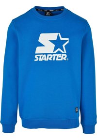 Felpa blu realizzata in morbido tessuto, con un grande logo bianco a forma di "S" e stella sul petto, e con polsini e orlo a costine.