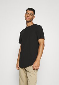 Black short-sleeve t-shirt with a round neckline, featuring a relaxed fit and a curved hemline, made from a soft cotton blend.