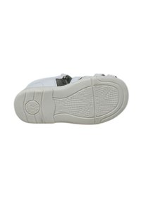 Suola di scarpa bianca in gomma con superficie testurizzata, caratterizzata da un logo circolare e l'impronta "FLEXIBLE ACTION SYSTEM". Design con bordi arrotondati.