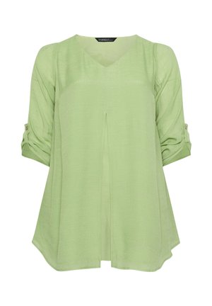 Blouse vert clair à manches longues avec col en V, pli frontal et manches retroussables maintenues par des pattes boutonnées.