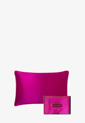 Bright pink silk pillow with matching boxed silk pillowcase labeled "Silke London" on a white background.