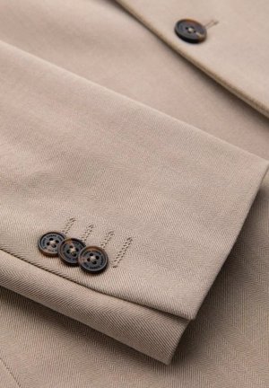 Beige herringbone fabric with three brown buttons on the cuff, featuring a smooth texture and clean, folded design.