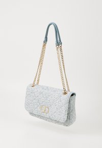 Light blue tweed handbag with a chain strap and gold hardware. Features a quilted texture and a front flap closure with a logo detail.