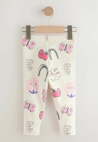 Valkoiset legginssit, joissa on värikkäitä kuosisuunnitelmia, kuten kukkia, perhosia, omenoita ja sateenkaaria. Valmistettu ribatusta kankaasta.