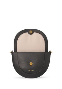 Black half-moon leather crossbody bag with beige interior lining, gold snap button closure, and "nat & nin" logo in gold lettering.