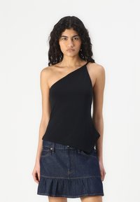 Black sleeveless top with an asymmetrical neckline, made of smooth fabric, paired with a denim skirt featuring a ruffled hem and pockets.