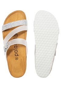 Witte sandalen met een glinsterende riem, kurken binnenzool en een gestructureerde witte rubberen buitenzool. Voorzien van een verstelbare gesp en een honingraattrend.