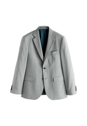 Gaiši pelēks pieguļošs žakete no teksturētas auduma ar atloku ar iespiešanu, divām priekšējām kabatām un tirkīza oderi. Piedurkņu gali ar sešām pogām.