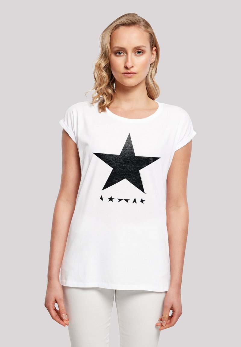 White cotton t-shirt with rolled sleeves, featuring a large black star graphic and smaller stars below. Simple, casual design.