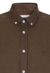 Braune Cordhemd mit Button-Down-Kragen, ausgestattet mit weißen Knöpfen und einem gestickten Vogel-Logo auf der linken Seite.