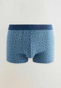 Blue patterned boxers with a dark blue elastic waistband featuring “NEXT” branding. Pattern consists of light blue geometric shapes.