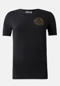Melnas īsām piedurknēm t-krekls, izgatavots no kokvilnas, ar zelta apļa logotipu krūšu daļā, uz kura attēlots teksts "Versace Jeans Couture". Gluda tekstūra.