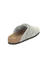 Gray suede slip-on shoe with a textured finish, cork midsole, and a lightweight black rubber outsole, featuring a simple strap design.