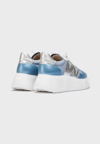 Blue leather and silver sneakers with a chunky white sole. Features a mix of textures, including smooth and metallic finishes.