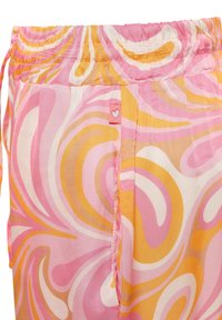 Mehrfarbige Hose mit einem gewundenen Muster in verschiedenen Schattierungen von Pink, Orange und Creme; elastischer Bund mit einem kleinen Herzanhänger.