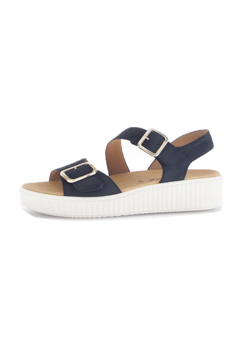 Marineblauwe sandaal met twee verstelbare banden, gouden hardware en een gestructureerde witte zool. De voetbed is bruin en gevoerd voor comfort.