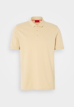 Beige poloshirt van katoen met een kraag, knoopsluiting met twee knopen en geborduurd "HUGO"-logo op de borst. Glad textuur.