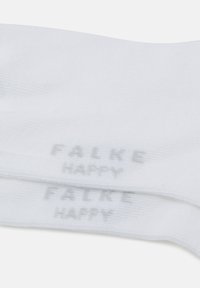 White cotton socks with a textured weave and printed branding. Features "FALKE HAPPY" in gray along the side. Lightweight and soft fabric.