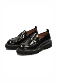Black leather loafers with a chunky rubber sole, featuring a smooth finish, decorative stitching, and dual front straps.