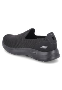 Schwarze Slip-On-Sneaker mit Mesh-Obermaterial, gepolsterter Sohle, Skechers-Logo an der Seite und praktischem Zugband an der Ferse.