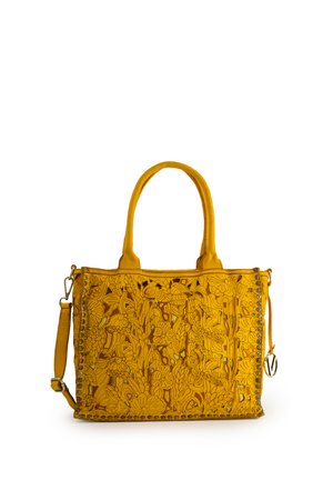 Yellow leather handbag with floral cut-out design, dual top handles, removable shoulder strap, and decorative stud accents.