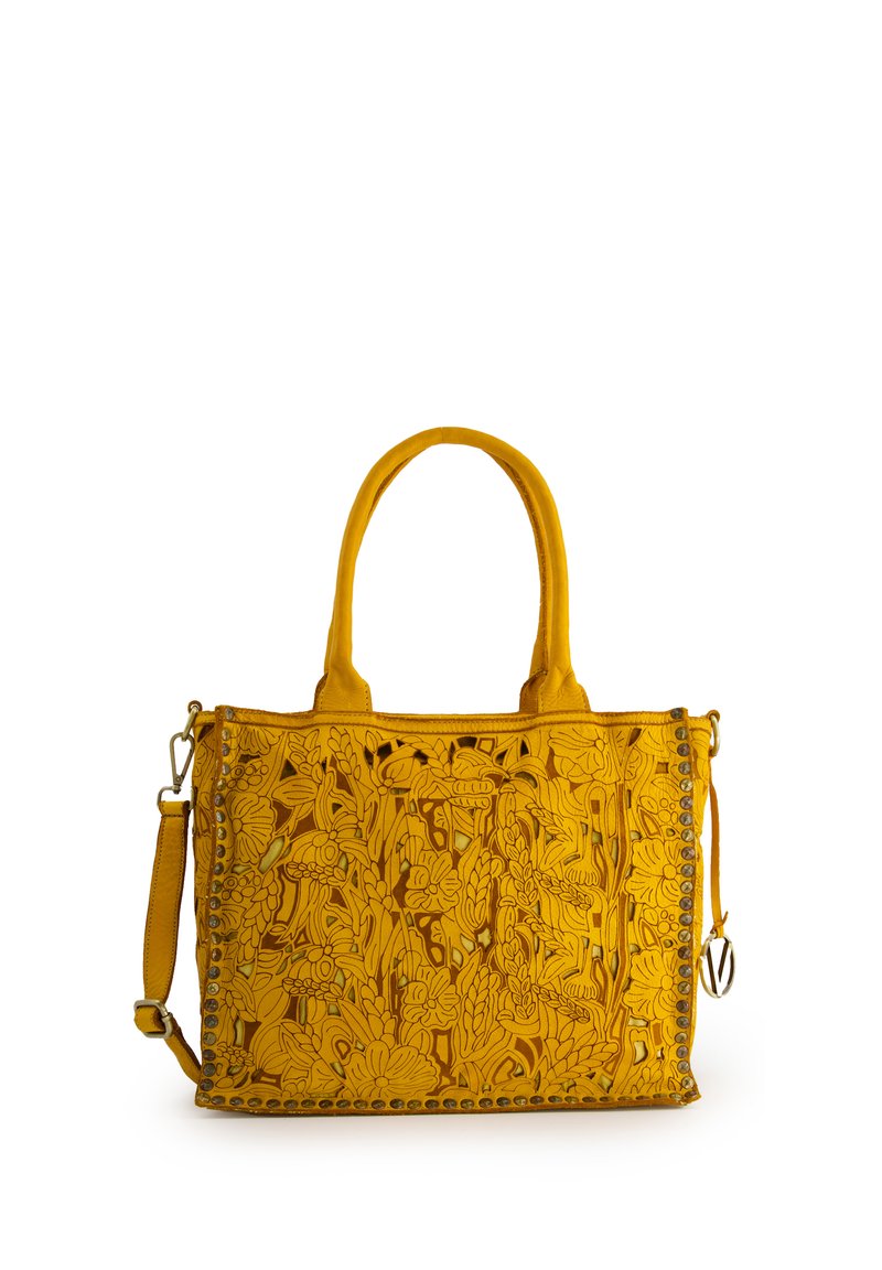 Yellow leather handbag with floral cut-out design, dual top handles, removable shoulder strap, and decorative stud accents.
