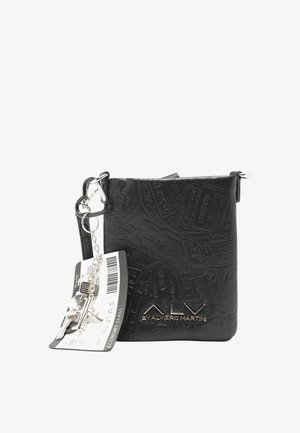 Piccola borsa a tracolla nera con motivo di timbri di viaggio in rilievo, logo ALSV in metallo e portachiavi con pass di imbarco e ciondoli a forma di aeroplano argentati.