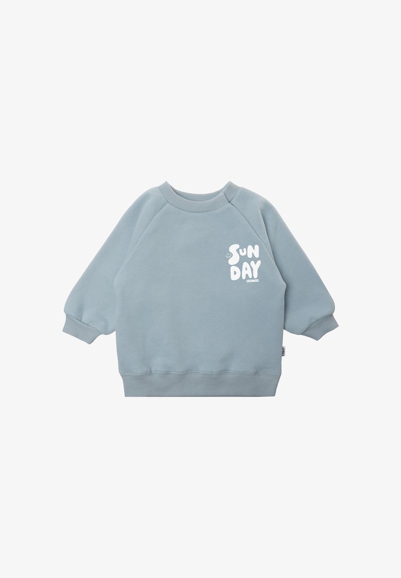 Light blue sweatshirt with raglan sleeves, ribbed cuffs and hem. Front features white text "SUN DAY." Made of soft, textured fabric.