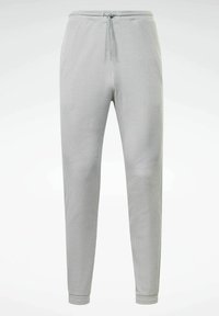 Ljust grå ribbade joggingbyxor med dragsko i midjan och smalnande ben. Tyget är mjukt och lätt texturerat för maximal komfort.