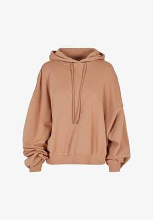 Prevelik bež dukserica s kapuco na vezanje, ribanim manžetama in strukturo tkanine. Ima širok, sproščen kroj in V-izrez.