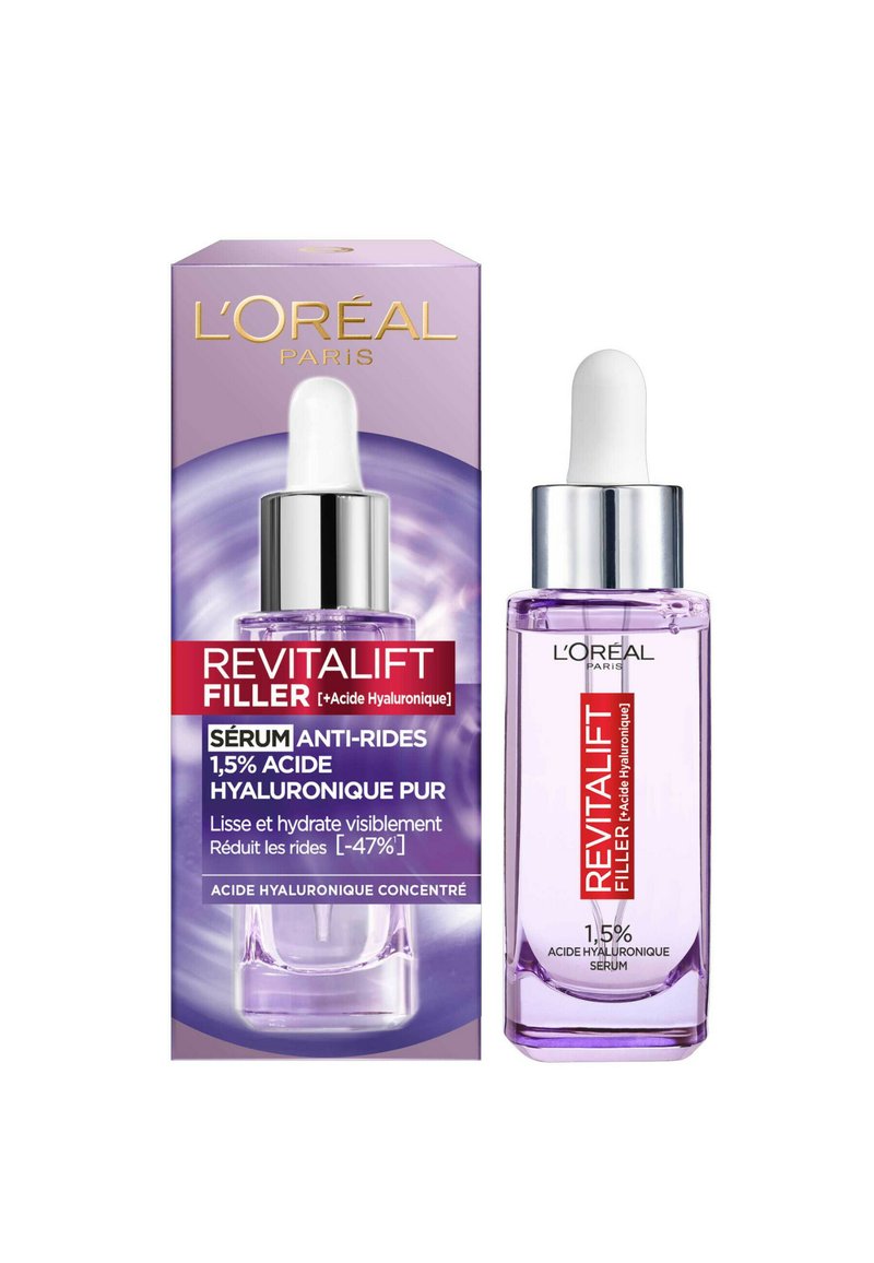 Boîte violette avec accents argentés, contenant un flacon compte-gouttes en verre clair. L'étiquette du produit indique "Revitalift Filler", avec des détails sur l'acide hyaluronique.