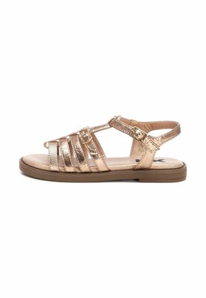 Sandalias metálicas de color oro rosa con suela plana, múltiples correas finas, hebilla en el tobillo y superficie texturizada para mayor agarre y comodidad.