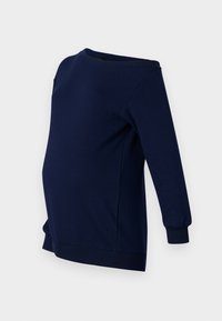 Felpa premaman blu navy con maniche lunghe, scollatura rotonda e orlo curvo. Realizzata in un tessuto morbido e elasticizzato per il massimo comfort.