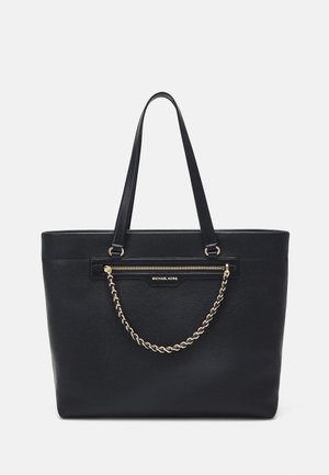 Sac cabas en cuir noir Michael Kors avec poignées doubles, poche zippée à l'avant et détail chaîne dorée décorative.