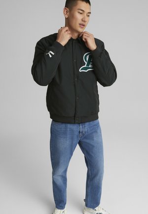 Puma TEAM BOMBER - Light jacket - black