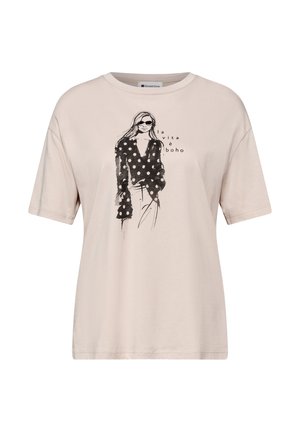 Beige t-shirt med sort skitse af en kvinde iført prikket top og solbriller, med teksten "la vita è boho" på fronten.