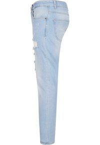 Vaaleansiniset skinny-farkut, joissa on kulutusta reiden kohdalla, frayed-reunat ja klassinen viiden taskun malli.
