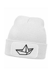 White knitted beanie with a folded cuff featuring a black outline of a paper boat on a white patch. Ribbed texture throughout.