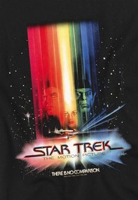 Star Trek t-shirt featuring a black background, vibrant rainbow stripes, iconic character silhouettes, and the text "THE MOTION PICTURE."