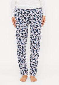 Pantalons de pyjama fleuris en marine avec un motif de petites fleurs roses et blanches. Dotés d'une taille élastique et de poches latérales. Texture de tissu lisse.