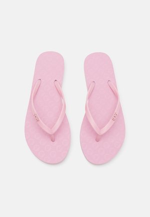 Pink flip-flops with textured soles, thin straps, and Roxy branding. The design features a repeating pattern on the footbed.