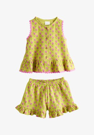 Sleeveless yellow top and shorts set with pink flower pattern, wooden buttons on top, and ruffled edges on sleeves, hem, and shorts.