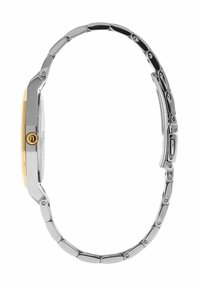 Montre-bracelet fine en métal avec bracelet en maillons argentés, lunette dorée et couronne dorée sur le côté, vue de profil.
