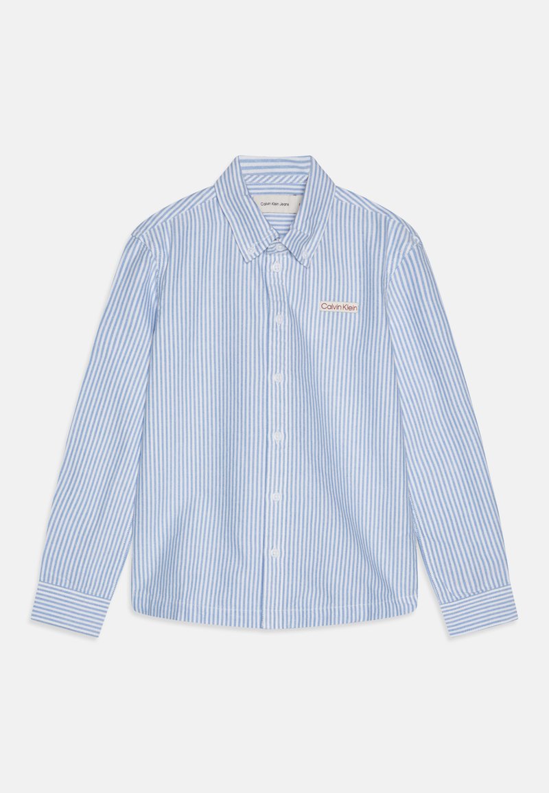 Striped long-sleeve shirt in light blue and white. Features a button-down collar, white buttons, and a Calvin Klein logo patch on the chest.