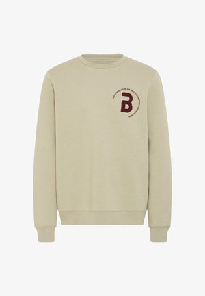 Sudadera beige con cuello redondo, mangas largas y puños de canalé. Presenta una letra 'B' bordada en color burdeos y un detalle de texto circular.