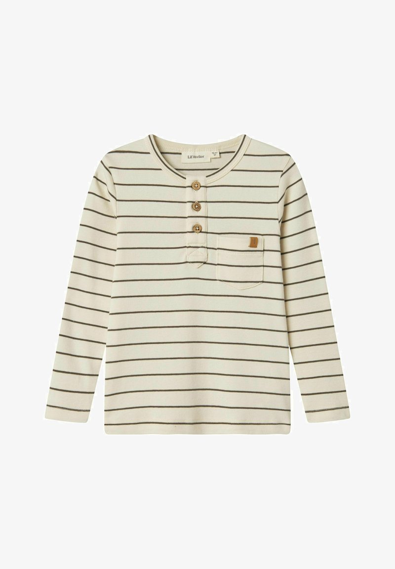 Ilgų rankovių organinės medvilnės marškiniai kremine spalva su plonomis rudomis horizontaliomis juostelėmis. Yra trys mediniai mygtukai ir kairėje krūtinės pusėje kišenė.