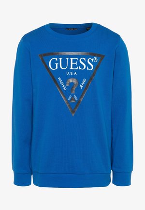Felpa blu con maniche lunghe, scollatura tonda, con logo triangolare nero e scritta “GUESS U.S.A. WASHED JEANS” in bianco e nero.