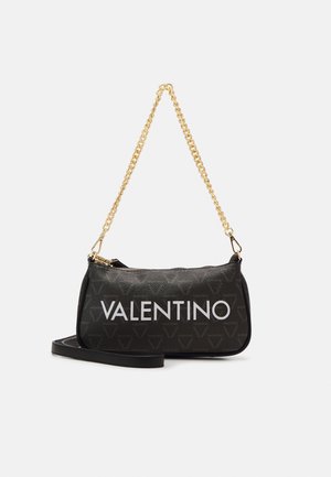 Black leather handbag featuring a gold chain strap, zipper closure, and bold white "VALENTINO" logo. Textured pattern of small logos.